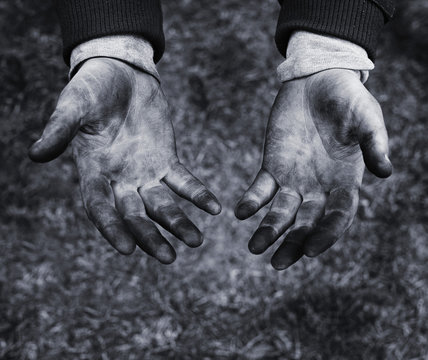 Hands of a mechanic in oil and fuel oil, close up, black and white