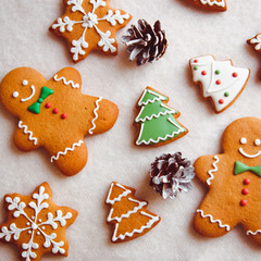 beautiful Christmas background with gingerbread men, Christmas trees and snowflakes with pine cones