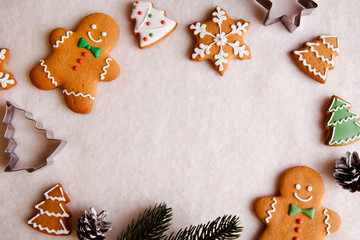 beautiful Christmas background with gingerbread men, Christmas trees and snowflakes with pine cones