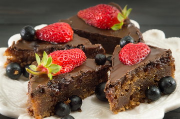 chocolate cake with whole strawberries on top