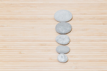 sea stones on bamboo background. Row pebbles.