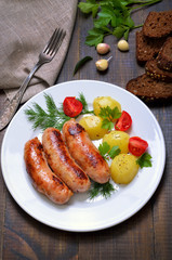 Grilled sausages and boiled potatoes