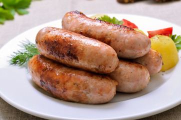 Grilled sausages on white plate