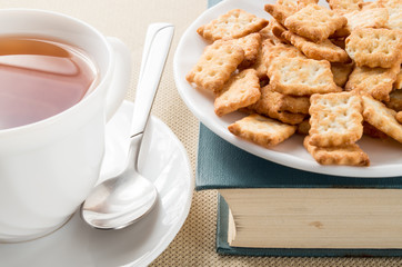Saucer with crackers on an old book