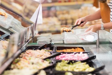 Woman choosing prepared meal 