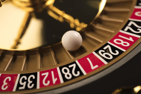 Casino theme. Golden roulette wheel closeup.