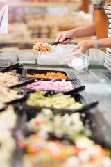 Close up view of hands picking prepared meals 