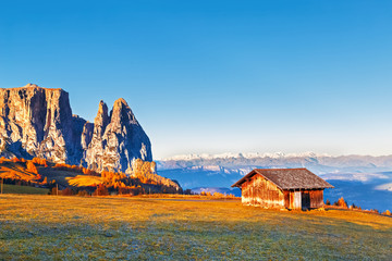 Cabin in Dolomite mountains at rock ans alps at background. Sunrising scene. Beautiful landscape with artistic pos tproduction.