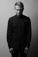 Portrait of brutal young man with short blond hair and freckles