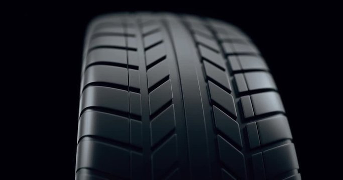 Close up on a car tire in motion, with deph of field effect. Seamless looping animation, 4k animation.