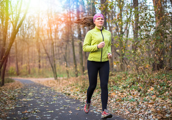 Sport woman doing outdoor cross training workout. Fitness in beautiful park