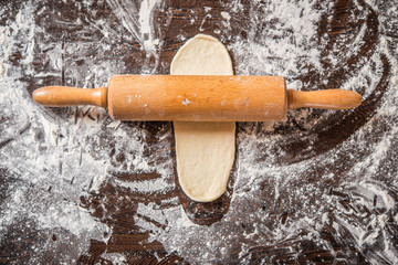 Rolled out dough on table with rolling pin