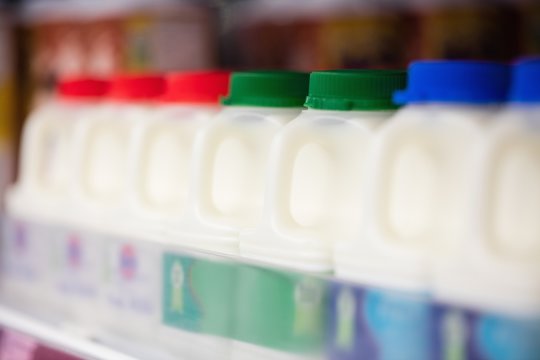 Milk bottles tidied in shelf 