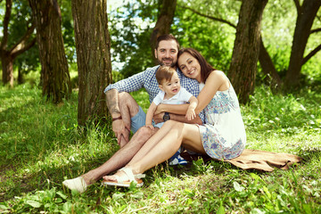 Fototapeta premium Portrait of happy family siting in the city park
