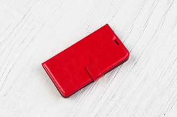 Red mobile case on rustic wooden background