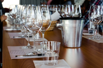 Table with glasses ready for wine tasting in a winery of Langhe (Italy)