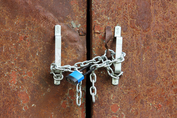 blue lock on the chain rusty door locks transformer station.