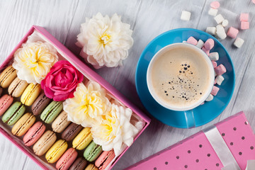 Colorful macaroons, coffee. Sweet macarons
