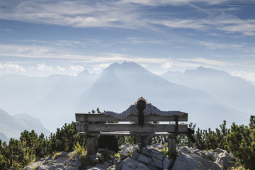 woman sitting on bench in mountains