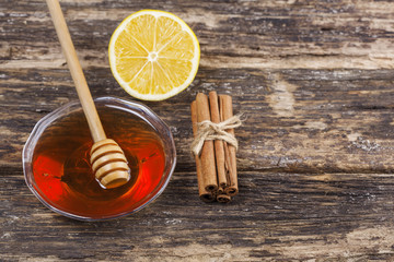 Honey,lemon and cinnamon on a wooden background