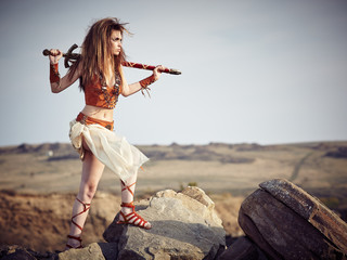 Beautiful girl in the clothes of a Viking or Amazon.