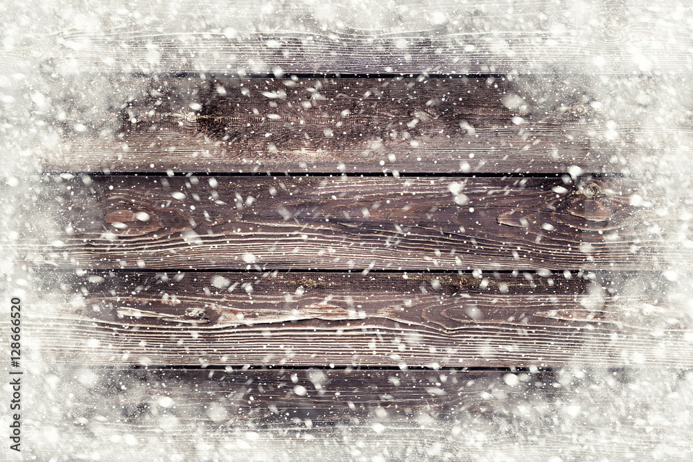 Wall mural the brown wood texture with snow flakes over it. winter background