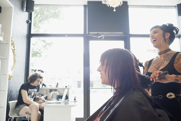A hair dresser styling a customer's hair.