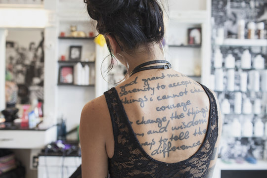 The tattooed back of a woman.