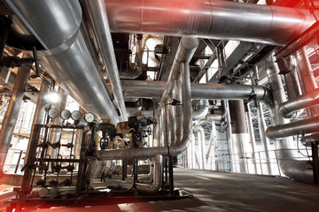 Equipment, cables and piping as found inside of a modern industr