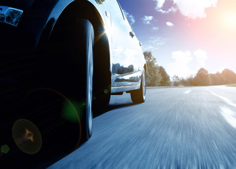 Front side view of black car driving fast