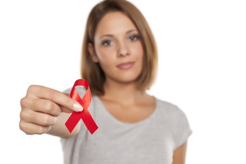 attractive young woman holding AIDS ribbon