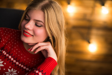 Portrait of a young attractive woman on the background lights