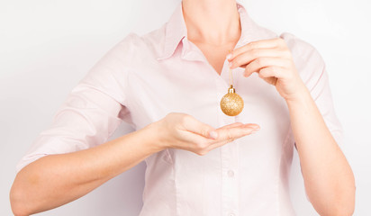 Woman holding a gold christmas ball