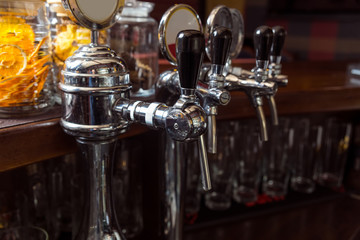 Close-up of the beer pipes on bar counter