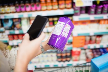 Hand photographing a product with a smartphone