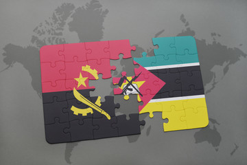 puzzle with the national flag of angola and mozambique on a world map.
