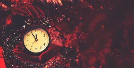 Woman holding alarm clock