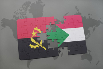 puzzle with the national flag of angola and sudan on a world map.