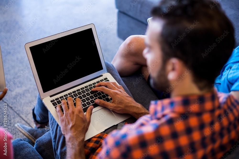 Aufkleber man siting on sofa using laptop
