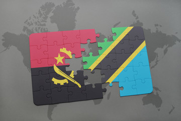 puzzle with the national flag of angola and tanzania on a world map.