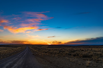 Fototapeta na wymiar Sunset over a rural dirt road