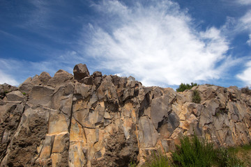 Fototapeta premium Natural stone wall with clouds and sky background