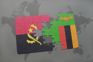 puzzle with the national flag of angola and zambia on a world map.