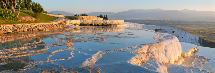 Panorama terraces from travertine in Pamukkale at sunset.