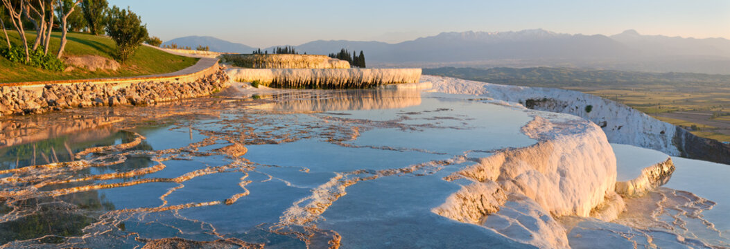 Fototapeta Panorama terraces from travertine in Pamukkale at sunset.