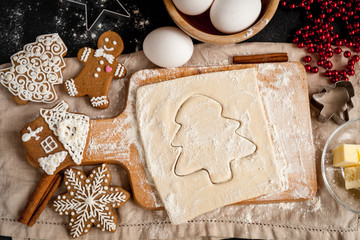 cooking christmas gingerbread on wooden background top view