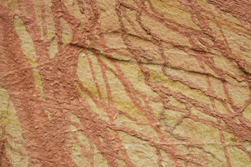 Naklejka premium Streaks of clay in yellow sandstone natural texture.