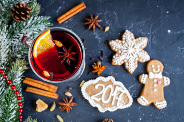 Christmas mulled wine with spices in cup on dark background