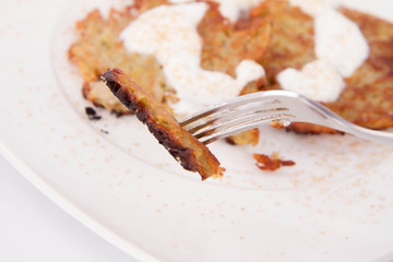 Potato Pancakes with cream and brown sugar eaten with a fork