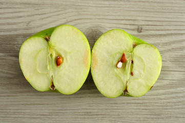 An apple that is sliced in two halves